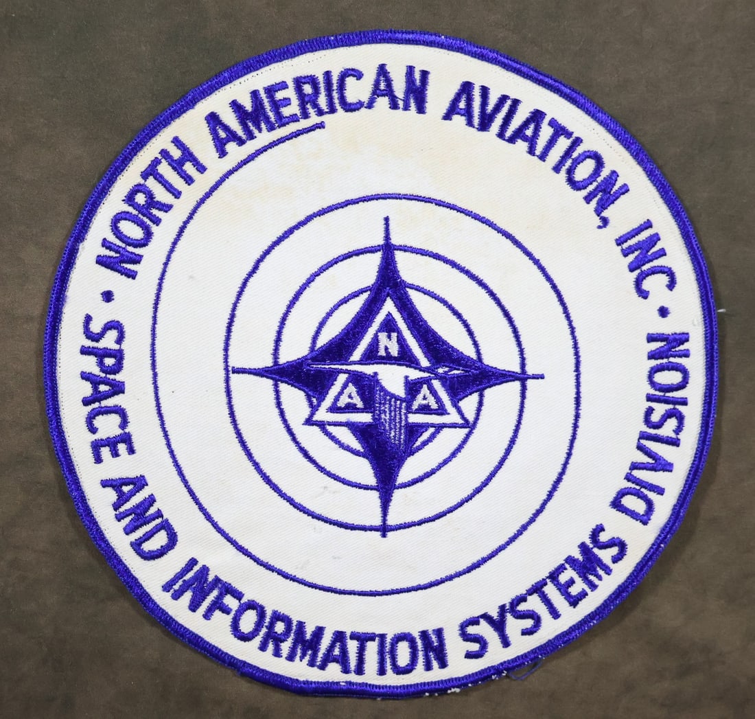 Original North American Aviation 8" Patch: An original North American Aviation 8" emblem cloth embroidered patch. The patch is in very good condition with light surface discoloration. The embroidered stitching is in excellent condition.
