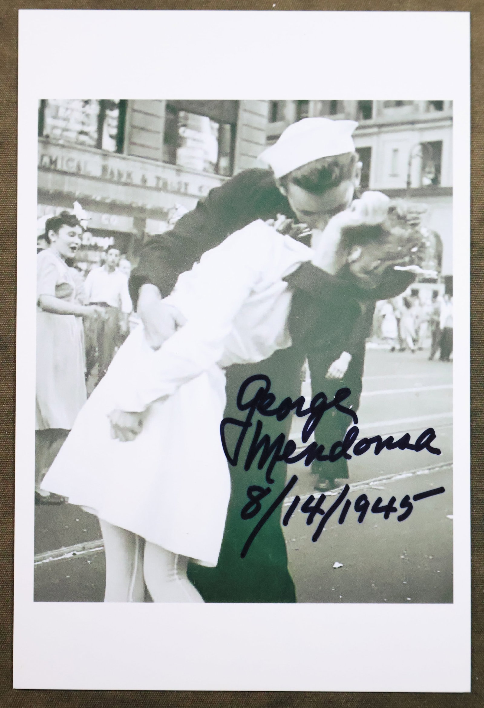 George Mendonsa - The Kissing Sailor - Ending WWII Photograph Card: This is a 6" x 4" photographic card showing an image Sailor George Mendonsa, the sailor pictured in the famous photograph kissing a woman in Times Square amid celebrations of the end of the second wor