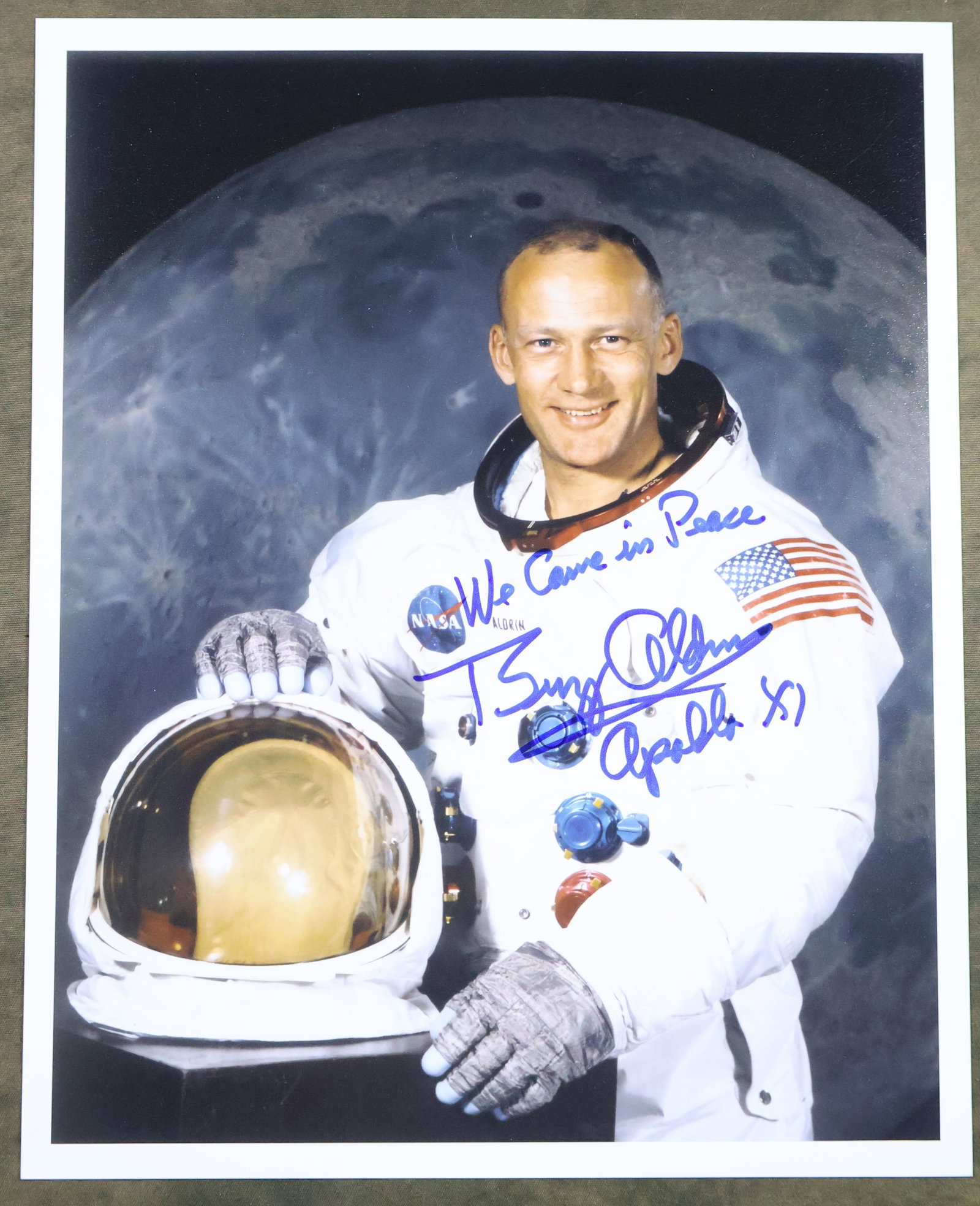 Buzz Aldrin Signed White Space Suit Photograph: A glossy color portrait photograph of astronaut Buzz Aldrin posing in his White Space Suit. This 8" x 10" photograph has been hand signed by Buzz Aldrin with "We Came in Peace" added. It is in excelle