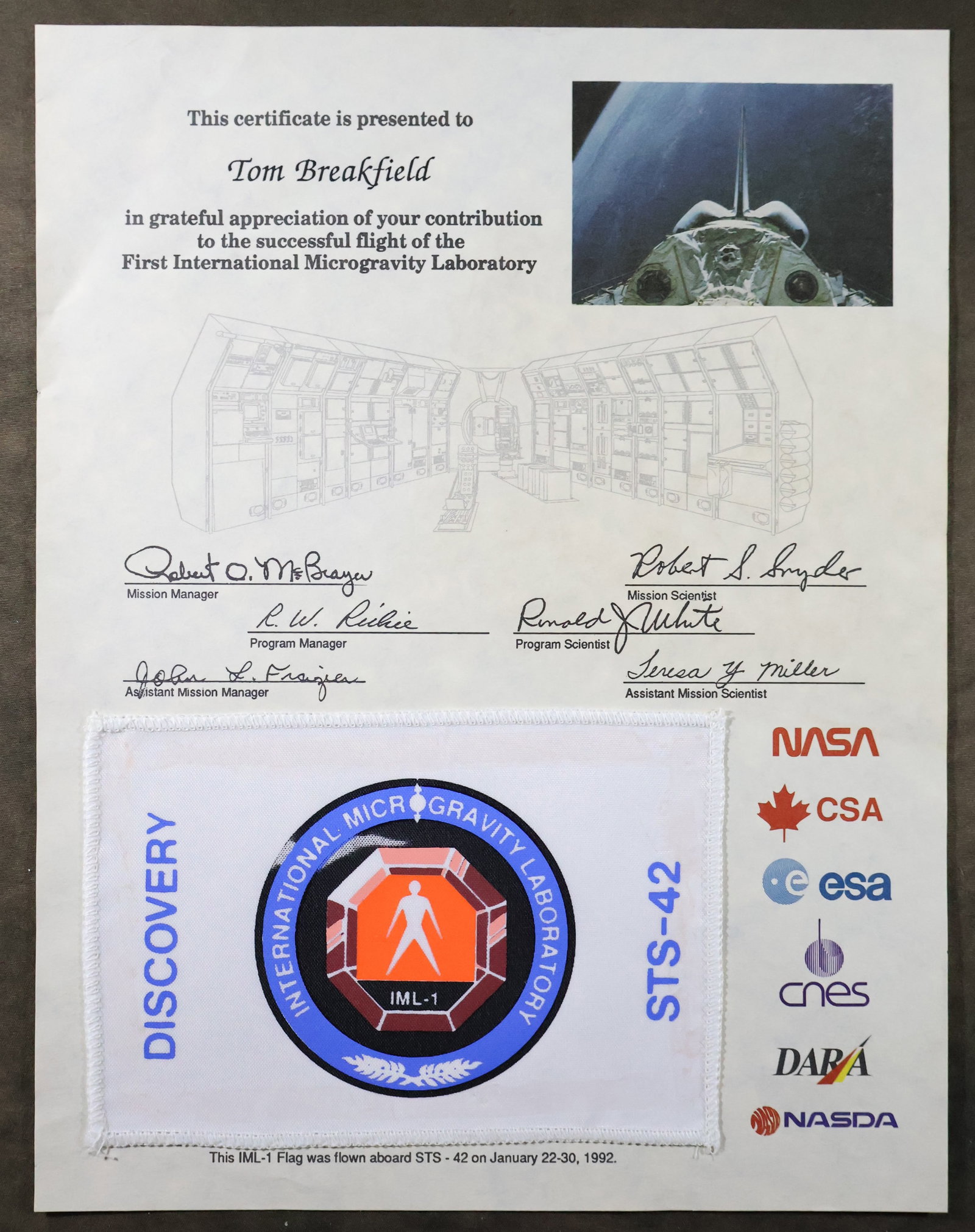 STS-42 Flown IML-1 Mission Flag Award: STS-42 appreciation award presentation that displays a 4" x 6" International Microgravity Laboratory 1 mission Flag that was flown aboard the Space Shuttle "Discovery" STS-42 mission. This 8.5" x 11" 