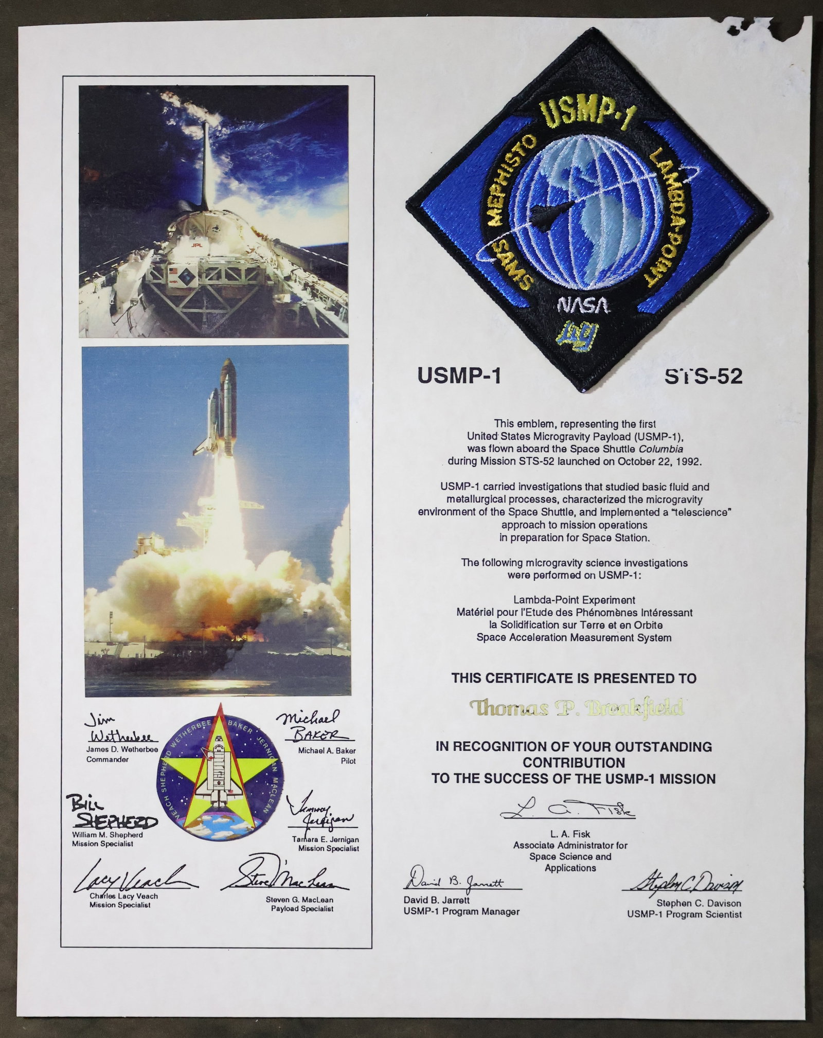 STS-52 Flown USMP-1 Mission Patch Award: A USMP-1 STS-52 appreciation award presentation that displays a 3.5" USMP-1 mission patch that was flown aboard the Space Shuttle "Columbia" STS-52 mission. This 11" x 14" presentation is in good cond