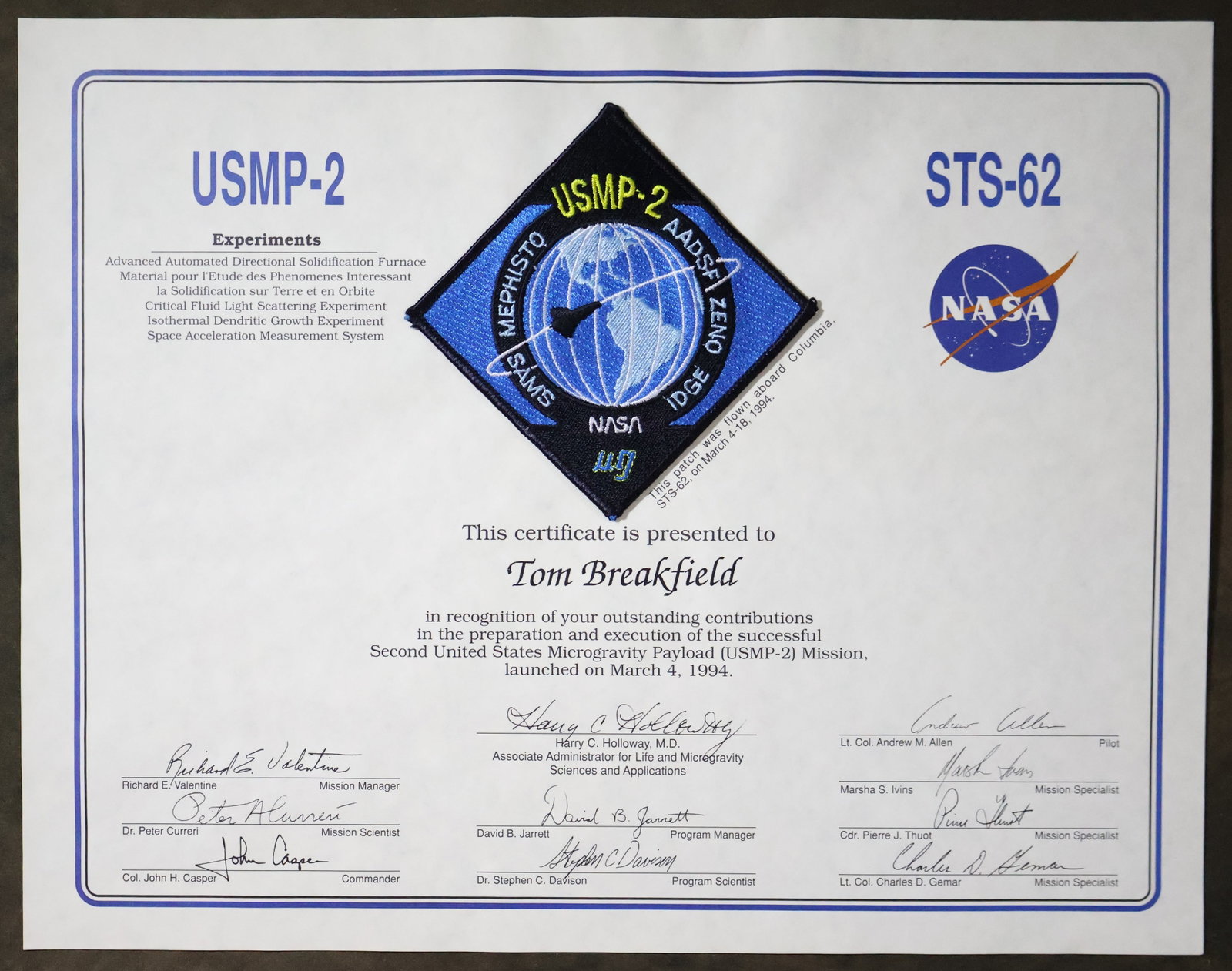 STS-62 Flown USMP-2 Mission Patch Award: A USMP-2 STS-62 appreciation award presentation that displays a 3.5" USMP-2 mission patch that was flown aboard the Space Shuttle "Columbia" STS-62 mission. This 11" x 14" presentation is in excellent