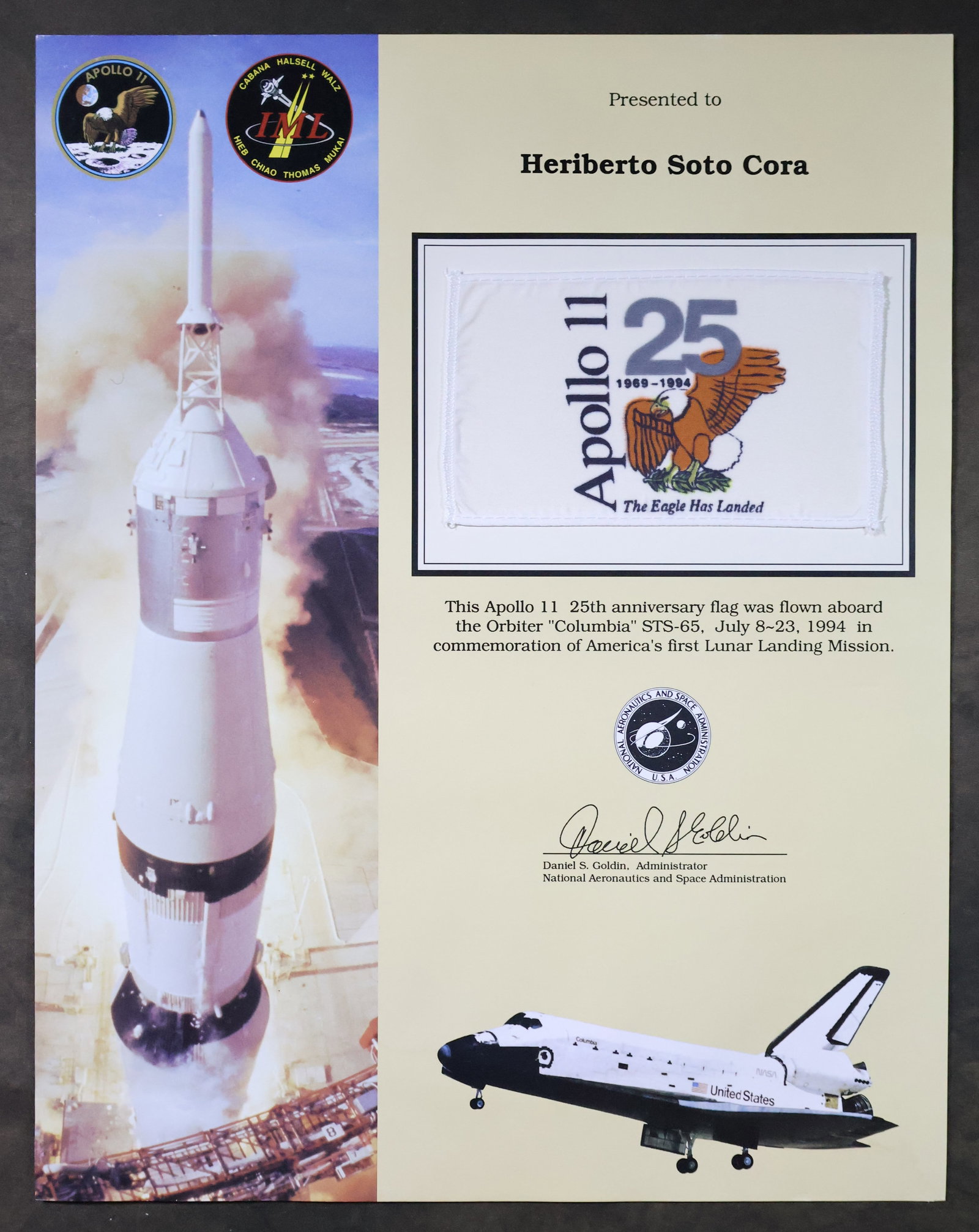 STS-65 Flown Apollo 11 Anniversary Flag Award: An Apollo 11 25th Anniversary appreciation award presentation that displays a 3" x 5" Apollo 11 25th Anniversary flag that was flown aboard the Space Shuttle "Columbia" STS-65 mission. This 11" x 14" 