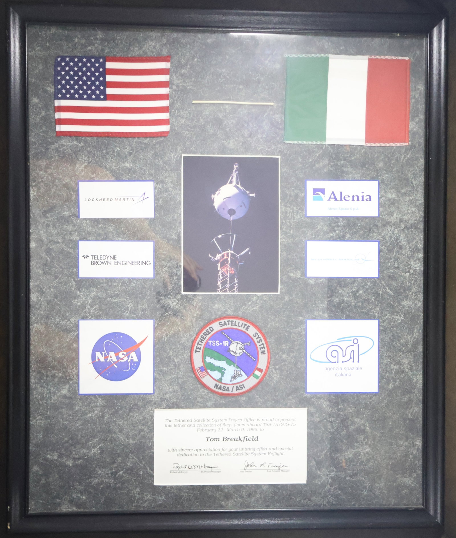 STS-75 Flown Flags & TSS1R Patch Award Framed: This is a framed Tethered Satellite System TSS-1R STS-75 appreciation award presentation that displays a 4" section of the Tethered Satellite System tether cord, 4" x 5.5" American Flag, 4.5" x 6" Ita