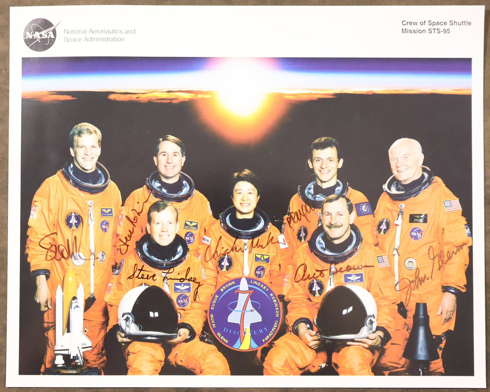 STS-95 Full Crew Signed NASA Lithograph: An original NASA issued lithograph for the STS-95 mission. This 8" x 10" lithograph has been hand signed by the full crew members - Curt Brown, Steve Lindsey, Stephen Robinson, Scott Parazynski,