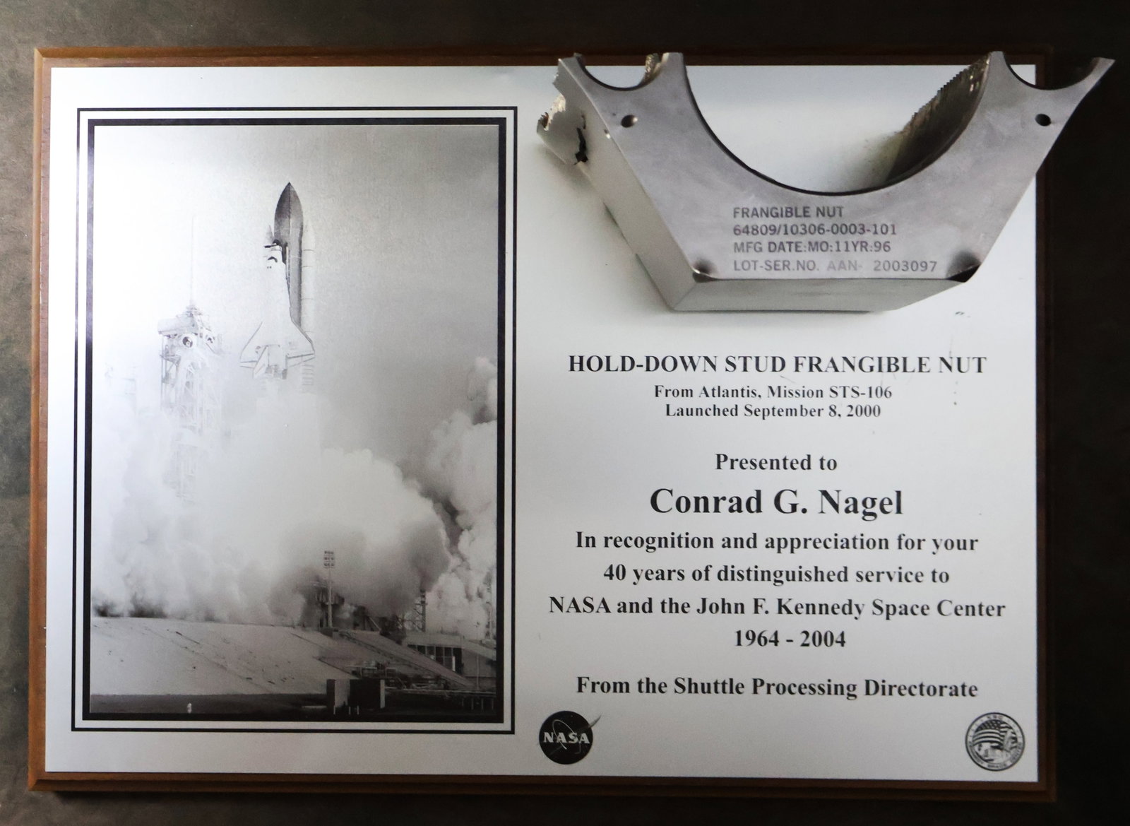 STS-106 NASA Frangible Nut Award: A wonderful display and conversation piece. A NASA/KSC plaque display showcasing half of a Hold Down Stud Frangible Nut from the Space Shuttle "Atlantis" from the STS-106 mission. This frangible nut