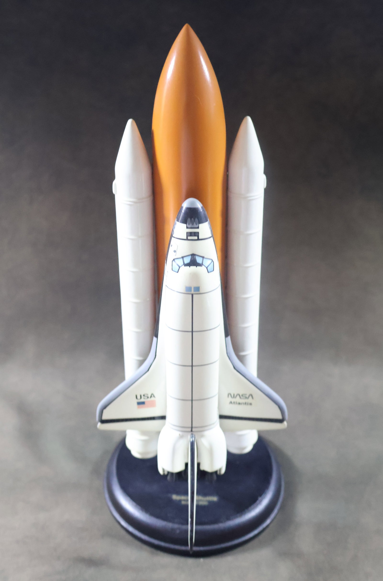 NASA Space Shuttle Atlantis 1/200 Scale Model: This is a NAS Space Shuttle Atlantis stack model. The model is made of mahogany wood and painted and 1/200 scale. It stands 12.5" tall with a 5" base. The model is in very good to excellent condition 