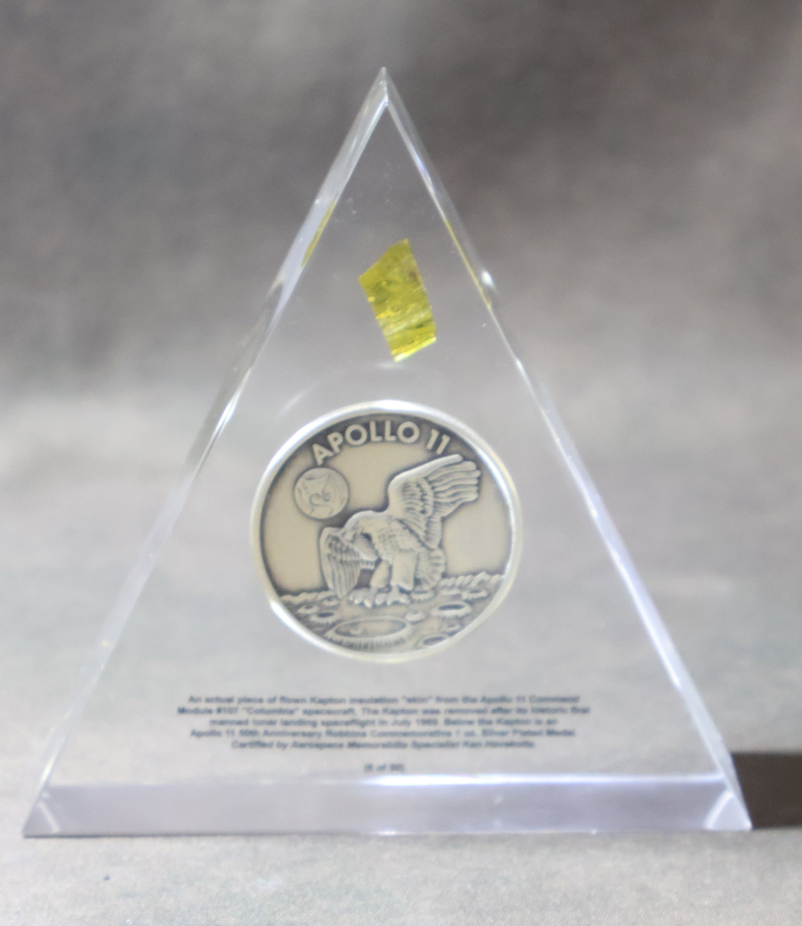 Flown Kapton Foil & Apollo 11 Robbins Medallion Commemorative Numbered Lucite: A Limited Edition #6/50 Commemorative Apollo 11 Lucite. The Lucite measures 4" x 4.25" x 1" and displays an Apollo 11 50th Anniversary Robbins 1 ounce Silver plated medallion. Above the medallion is a