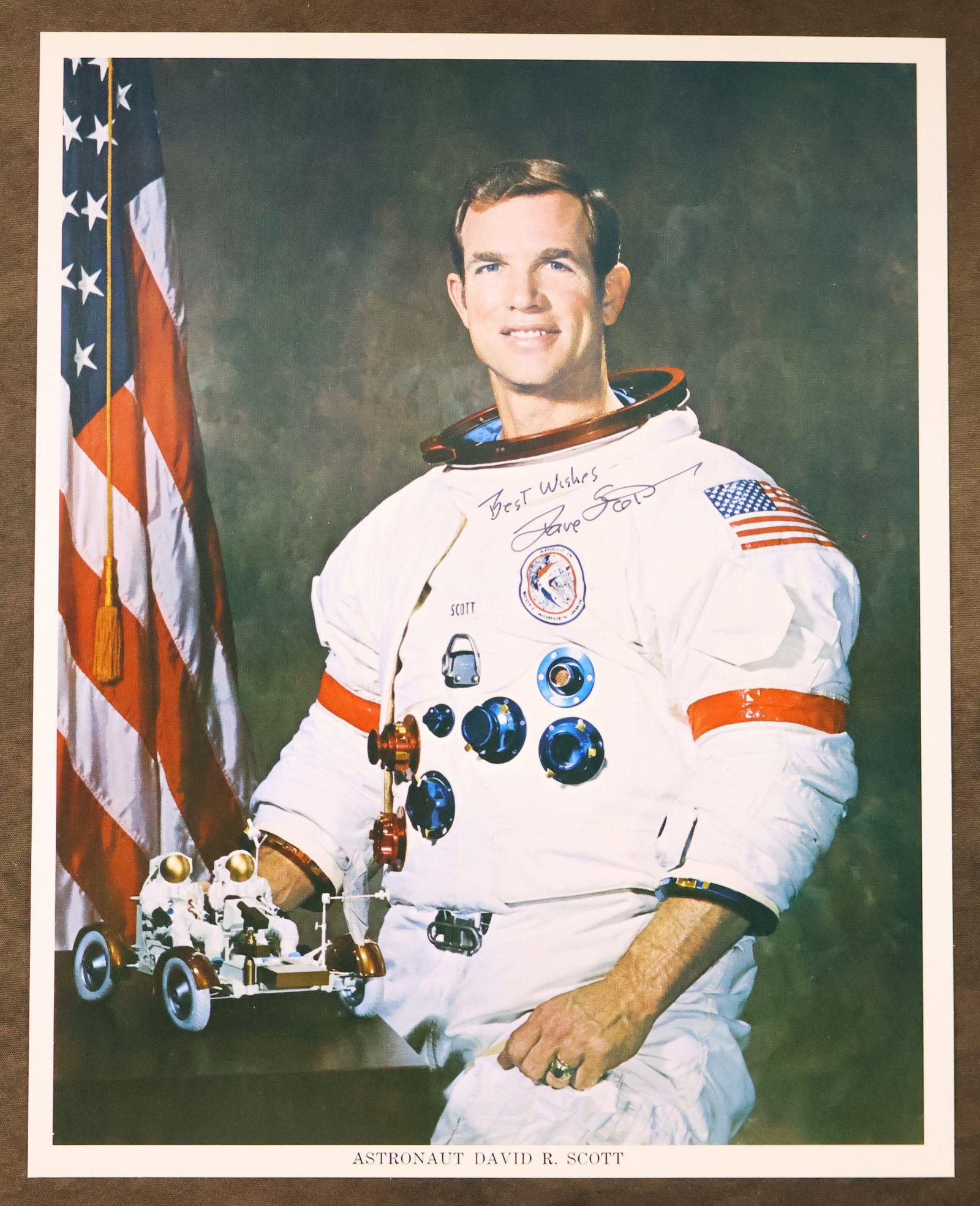 Vintage NASA Dave Scott Signed Lithograph: A vintage NASA issued lithograph of astronaut Dave Scott posing in his white space suit. This 8" x 10" lithograph has been hand signed by Dave Scott with "Best Wishes" added. It is in near mint condit