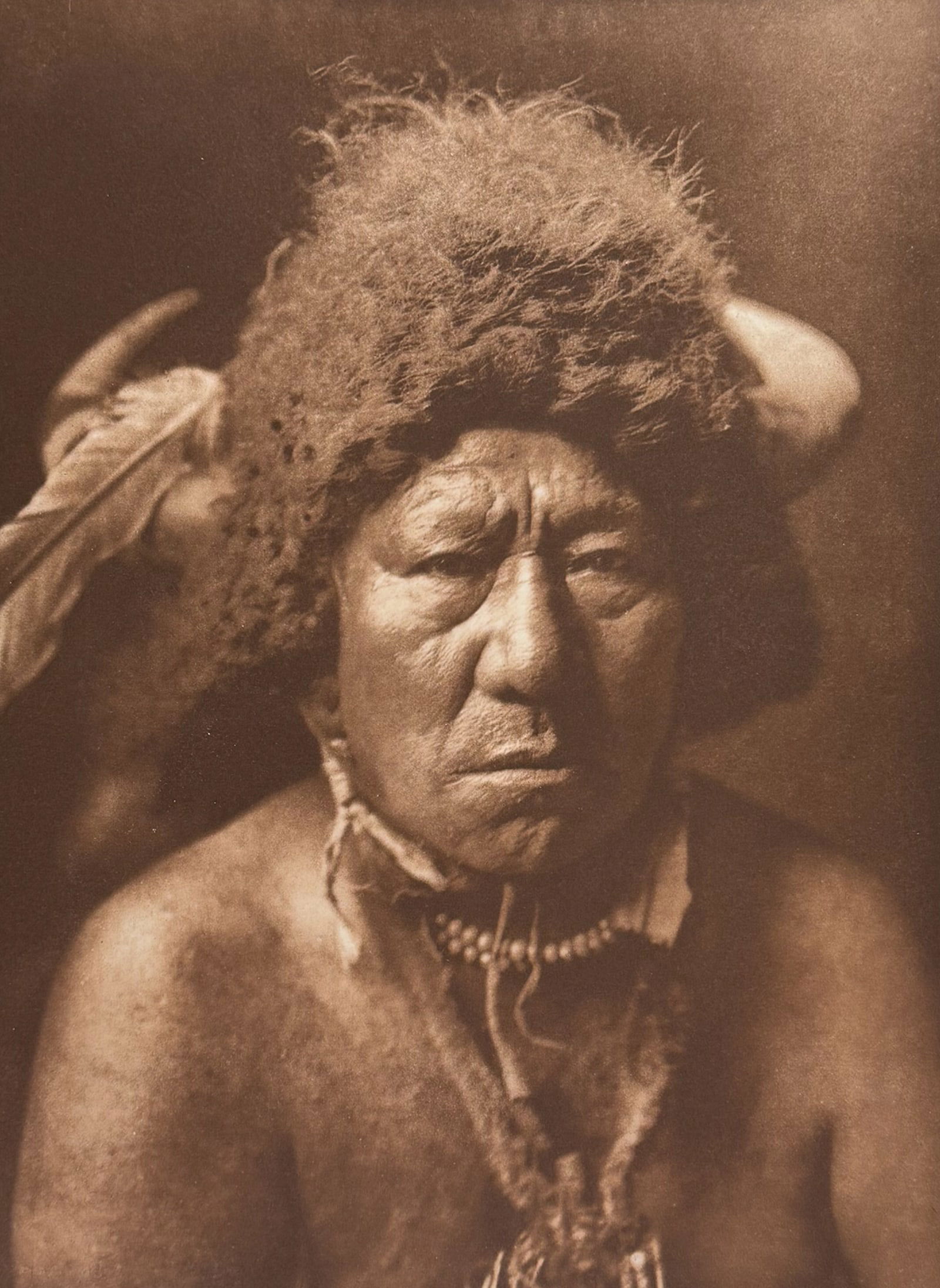Edward Curtis, Folio - Bull Neck - Arkara. 156: This moving photogravure in folio size is from Edward Curtis's The North American Indian being a Series of Volumes Picturing and Describing the Indians of the United States and Alaska. Edited by Frede