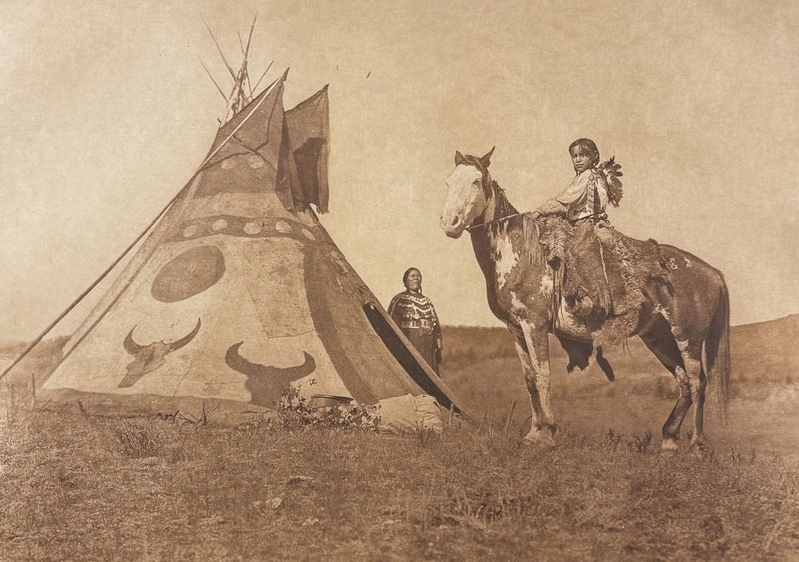 Edward Curtis, Folio - A Painted Tipi - Assiniboin: Curtis's description of the image: A tipi painted with figures commemorative of a dream experienced by its owner is a venerated object. Its occupants enjoy good fortune, and there is no difficulty in