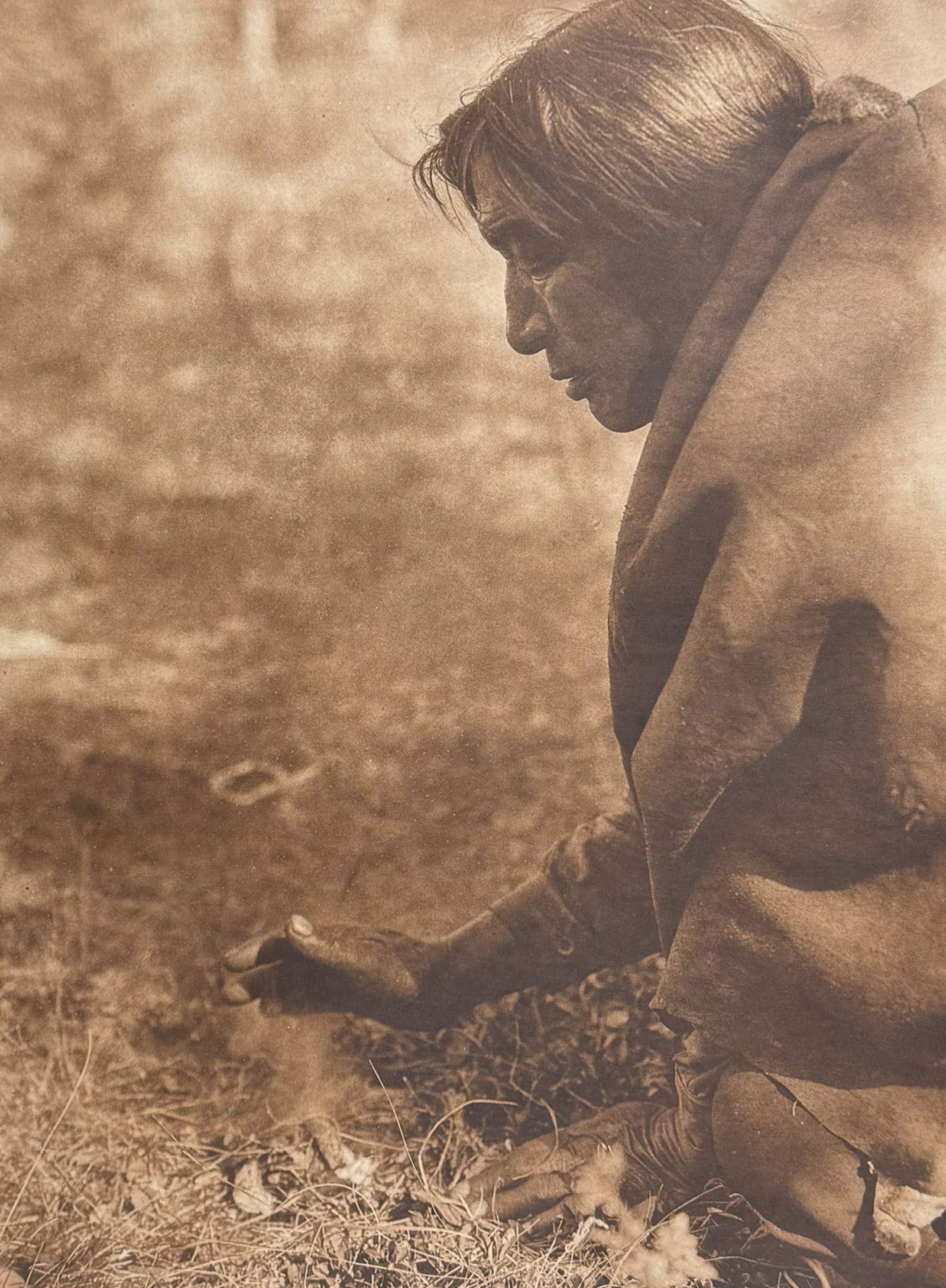 Edward Curtis, Folio - Kindling Fire - Assiniboin: Curtis's description of the image: The fire-drill is unknown to the oldest Assiniboin traditionists, but striking fire from flint was apparently an aboriginal method. Description of the work: This mov