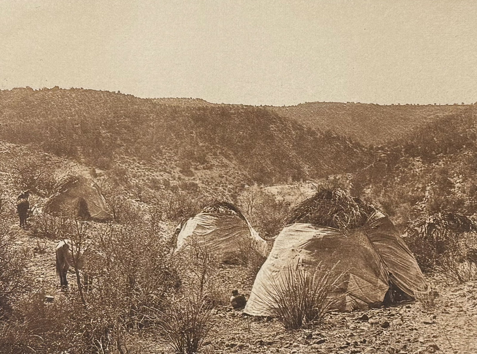 Edward Curtis - Mescal Camp - Apache: This moving photogravure in quarto size is from Edward Curtis's The North American Indian being a Series of Volumes Picturing and Describing the Indians of the United States and Alaska. Edited by Fred