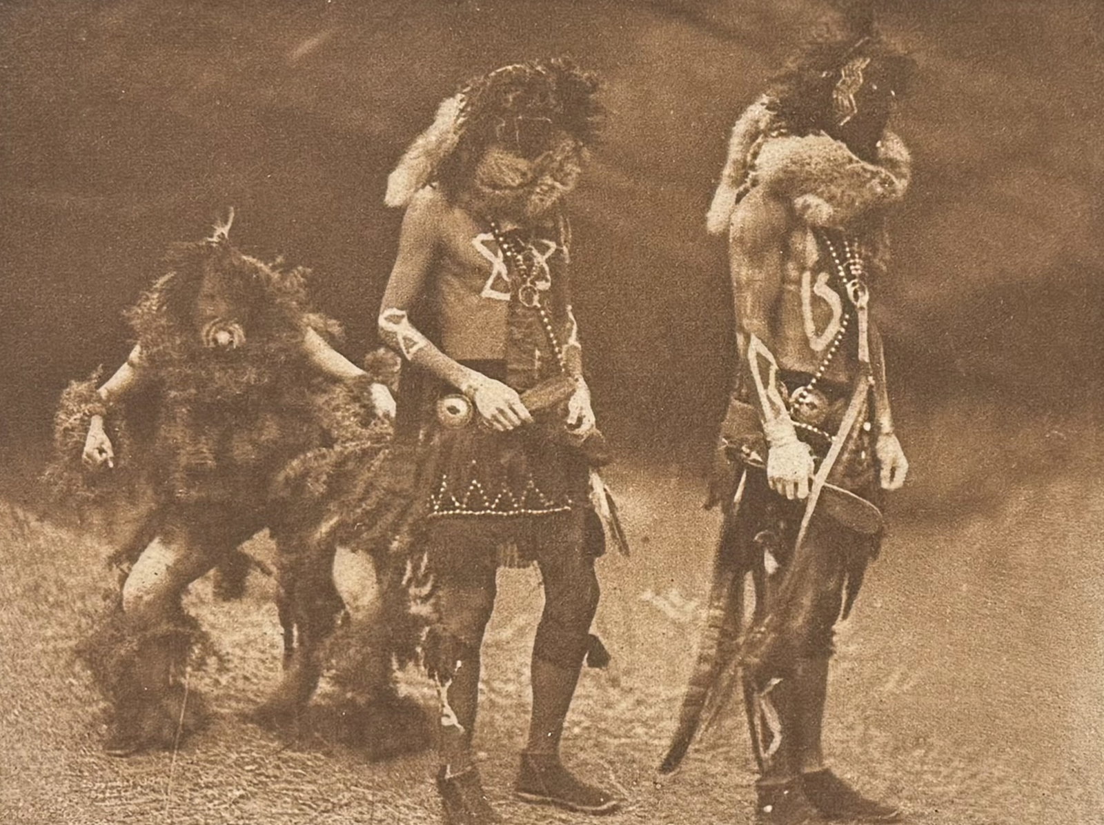 Edward Curtis - Tonenili, Tobadzischini, Nayenezgani - Navaho: This moving photogravure in quarto size is from Edward Curtis's The North American Indian being a Series of Volumes Picturing and Describing the Indians of the United States and Alaska. Edited by Fred