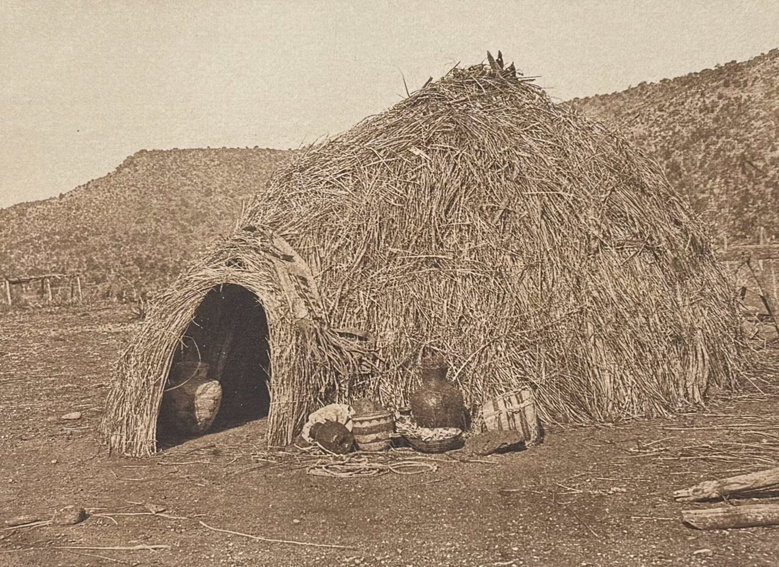 Edward Curtis - Primitive Apache Home: This moving photogravure in quarto size is from Edward Curtis's The North American Indian being a Series of Volumes Picturing and Describing the Indians of the United States and Alaska. Edited by