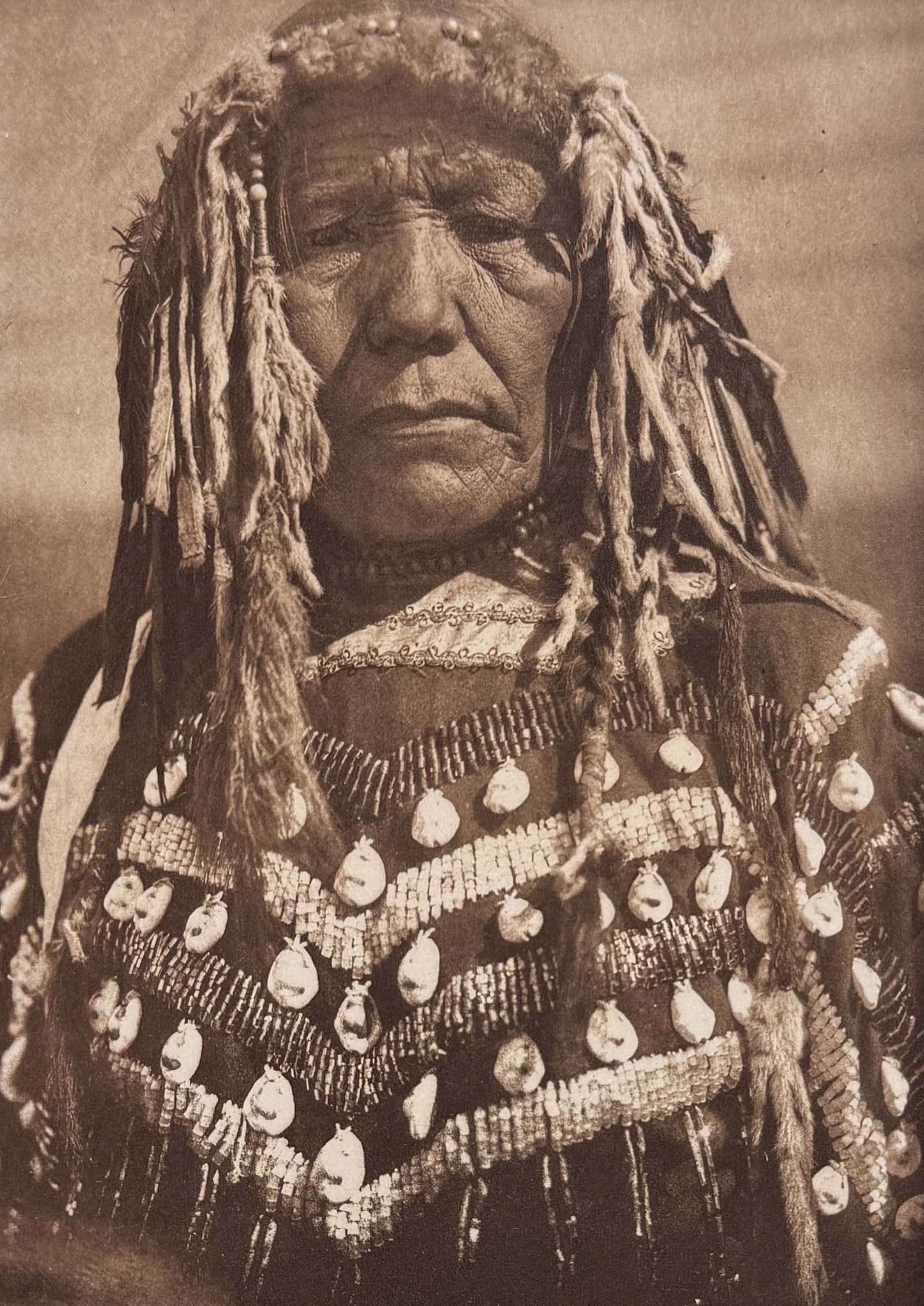 Edward Curtis - Piegan Woman: This moving photogravure in quarto size is from Edward Curtis's The North American Indian being a Series of Volumes Picturing and Describing the Indians of the United States and Alaska. Edited by Fred