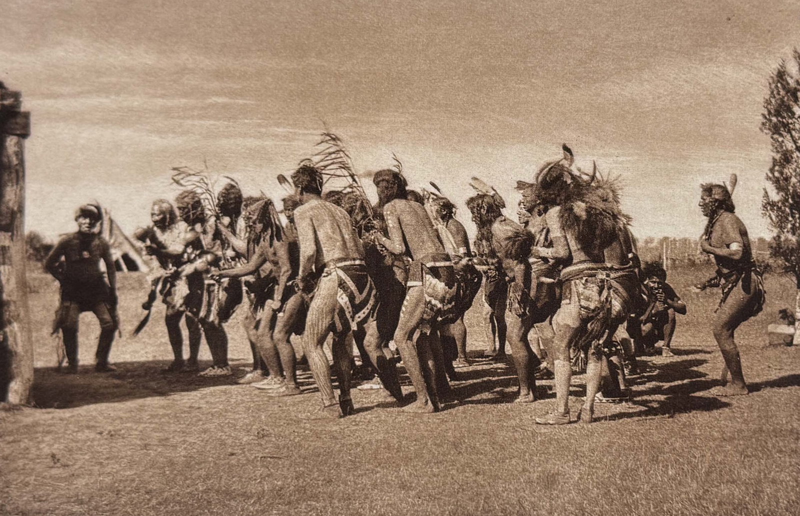 Edward Curtis - Dancing into the Medicine-lodge- Arikara: This moving photogravure in quarto size is from Edward Curtis's The North American Indian being a Series of Volumes Picturing and Describing the Indians of the United States and Alaska. Edited by Fred