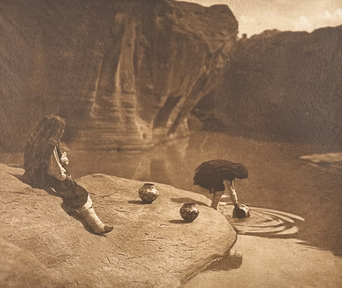 E Curtis, Folio, Japanese Tissue - At the Old Well of Acoma: Description of the image: Members of Coronado's army of explorers in 1540 and Espejo in 1583 noted the "cisterns to collect snow and water" on the rock of Acoma. Description of the work: This moving