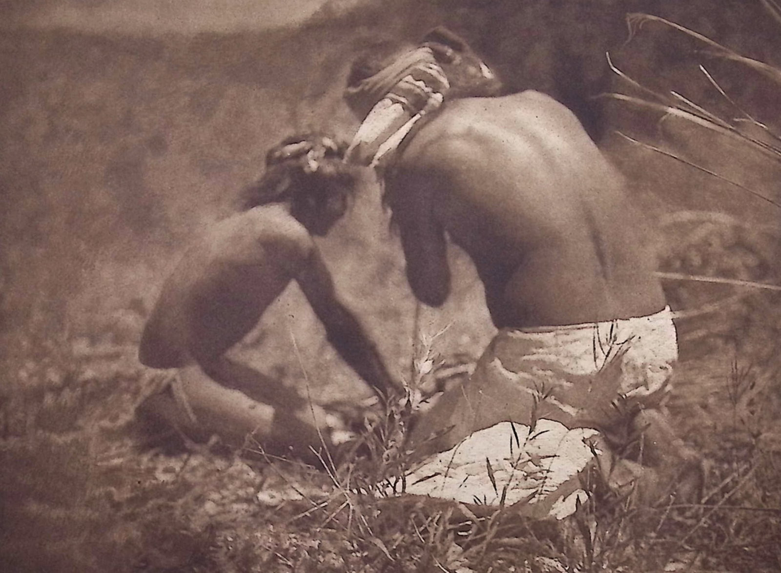 Edward Curtis - The Fire Drill - Apache: This moving photogravure in quarto size is from Edward Curtis's The North American Indian being a Series of Volumes Picturing and Describing the Indians of the United States and Alaska. Edited by Fred