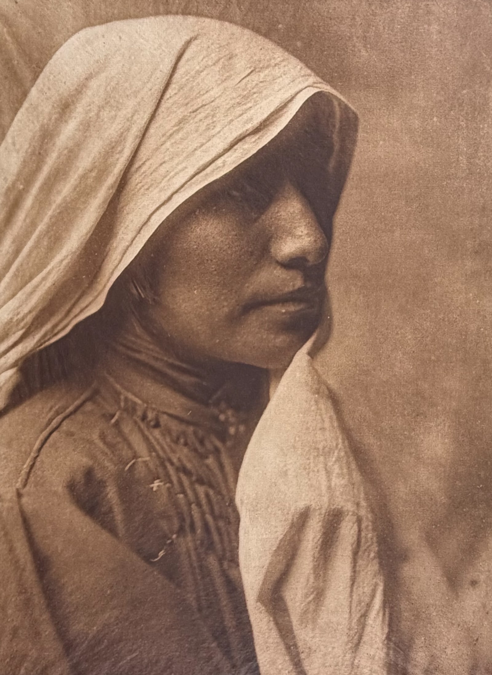 E Curtis, Folio, Japanese Tissue in Overmat - A Taos Woman: This moving photogravure is from Edward Curtis's The North American Indian being a Series of Volumes Picturing and Describing the Indians of the United States and Alaska. Edited by Frederick Webb