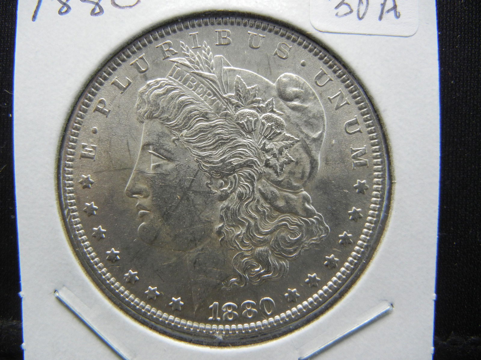 1880 Morgan Dollar.   Uncirculated.  Tough date to (1 of 3)