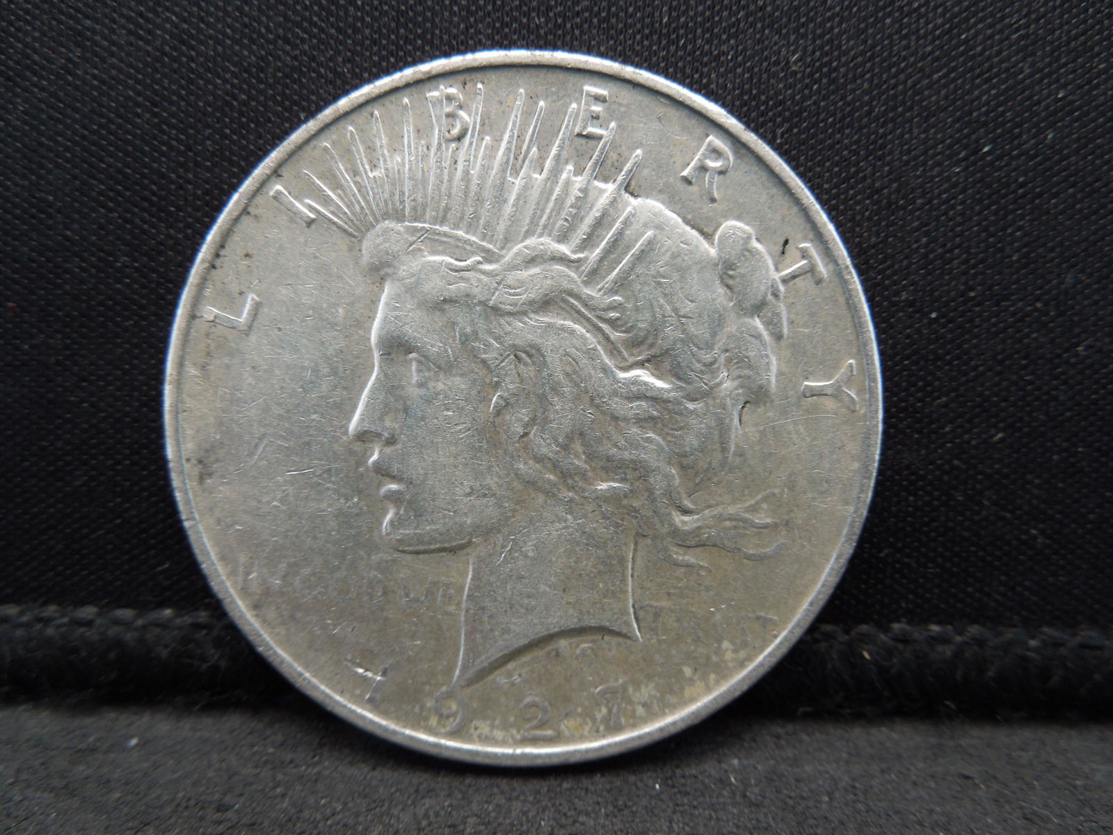 1927-D Semi-Key Date Peace Silver Dollar. (1 of 2)