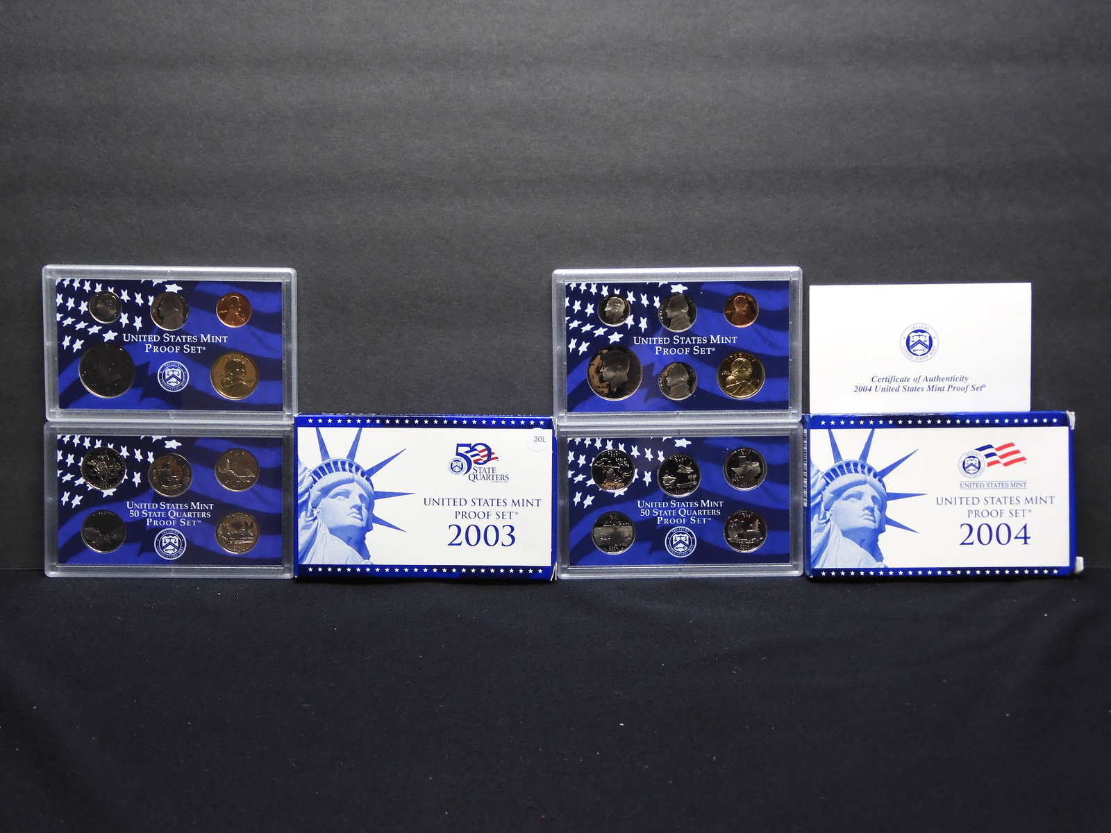 2003 and 2004 United States Mint Proof Sets With: 2003 and 2004 United States Mint Proof Sets With Original Gov't Packaging & COA's. 21 Total Coins.