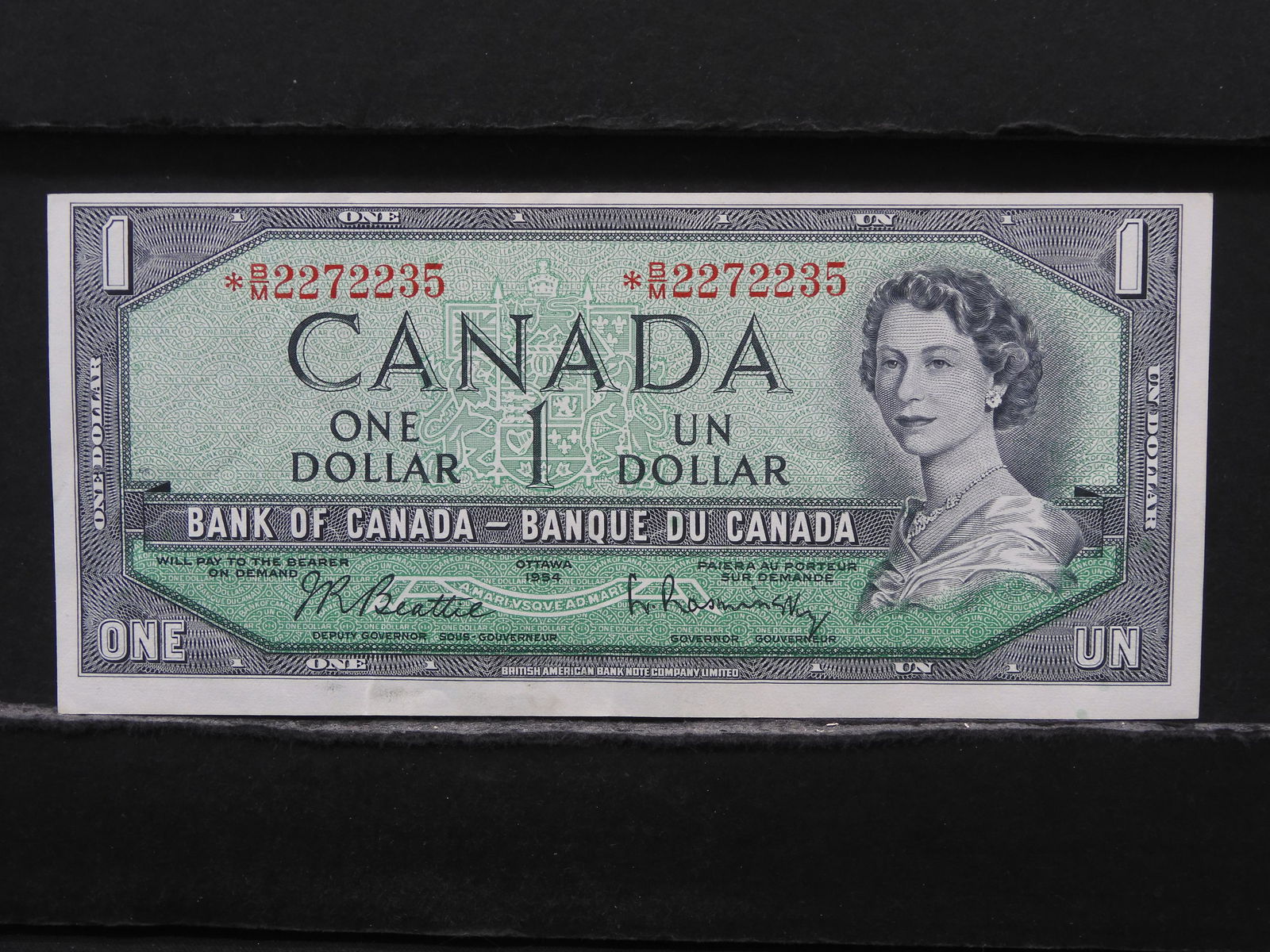 1954 Canada $1 *Star Replacement Note.  Crisp AU+. (1 of 3)
