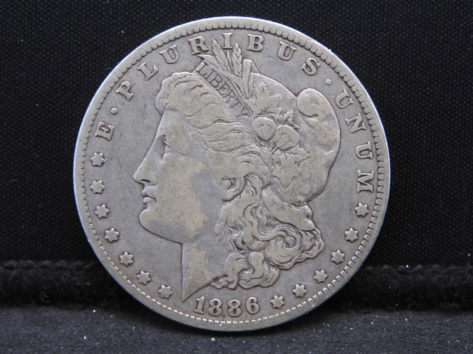 1886-O Morgan Dollar.  Original.  Very expensive in (1 of 3)