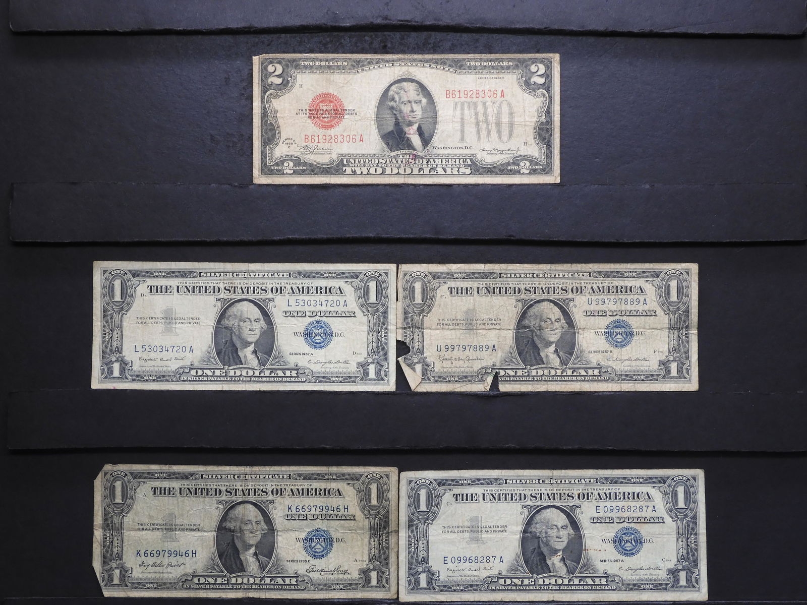 4 - $1 Silver Certificates & 1 - 1928-C $2 Red Seal. (1 of 7)