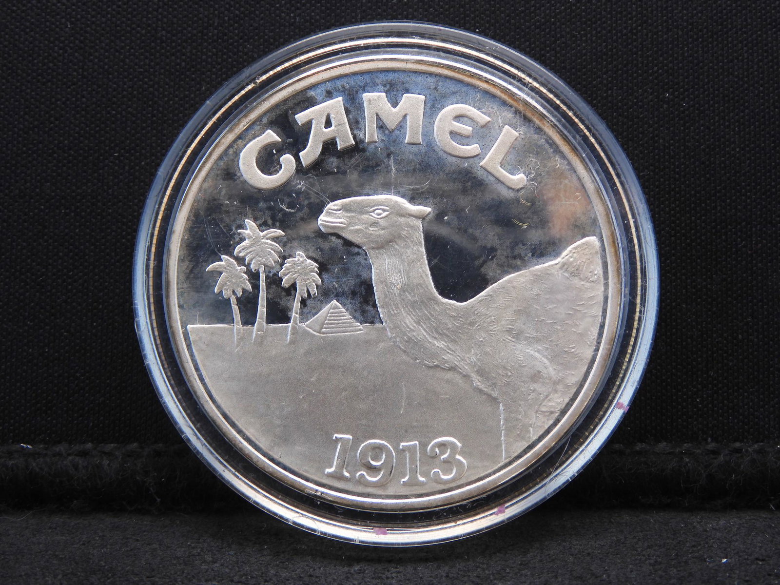 Silver - 1 Troy Oz. Round (Unmarked) w/ Camel Cigarette (1 of 2)