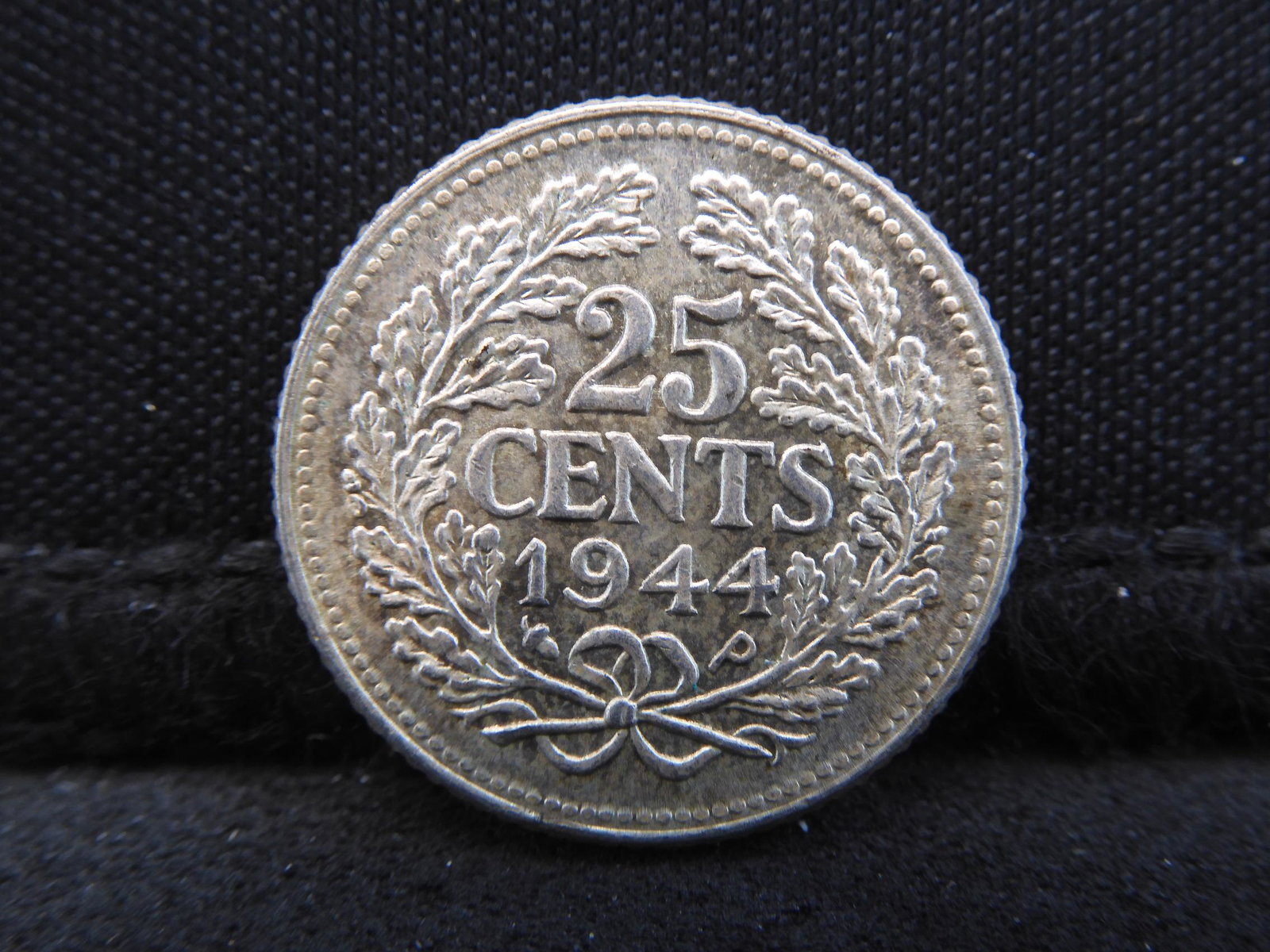 1944-P Netherlands 25 Cents 64% Silver Coin. Coin: 1944-P Netherlands 25 Cents 64% Silver Coin. Coin Weighs 0.11 Troy Oz. Wilhelm Portrait.