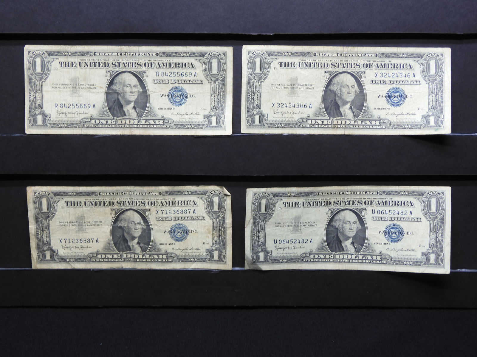 Four 1957-B $1 Blue Seal Silver Certificates. (1 of 6)
