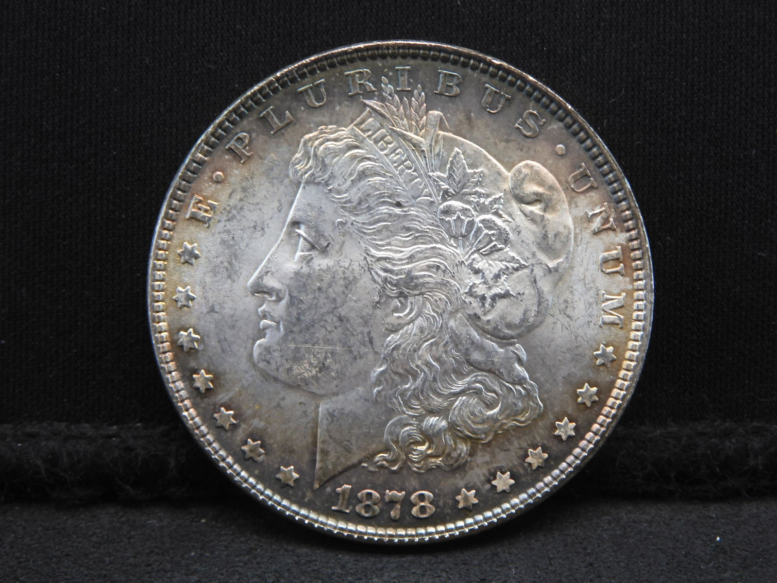 1878 Seven Tail Feather Morgan Dollar. Choice BU. Rainbow toning. (1 of 3)