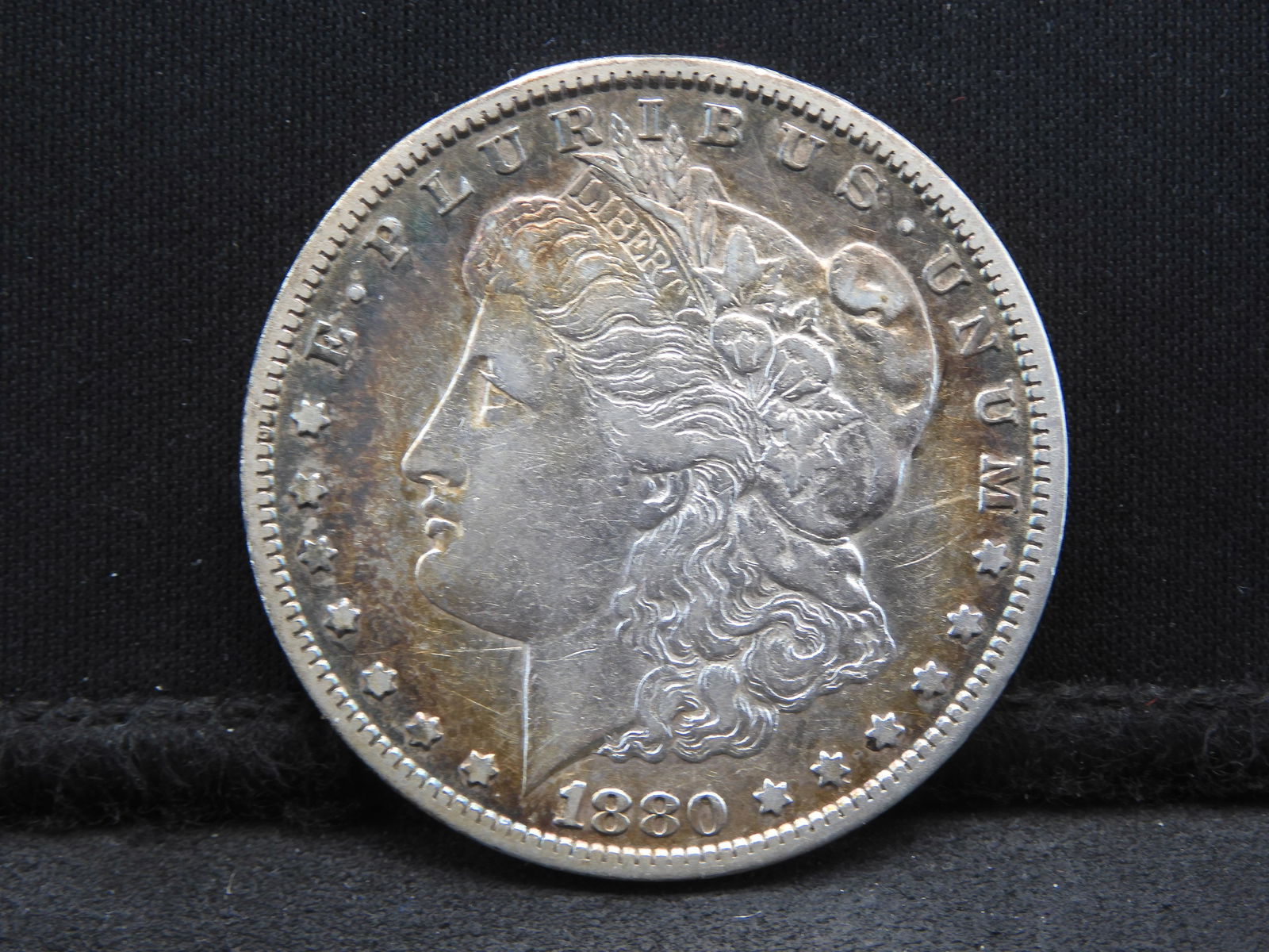 1880-CC Morgan Dollar.  XF detail.  Scarce/key date.  Rainbow tone. (1 of 3)