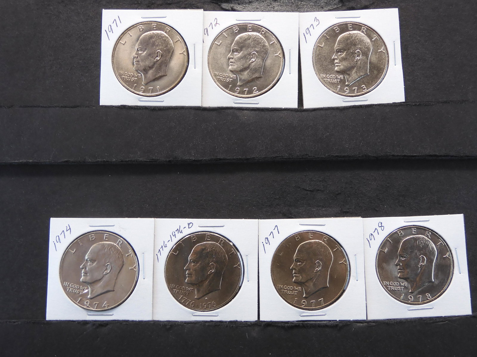 7 - Eisenhower Dollars 1971 to 1974 & 1976 to 1978 all Carded in 2x2's (1 of 7)