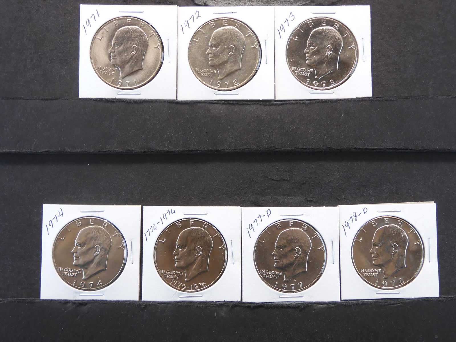 7 - Eisenhower Dollars 1971 to 1974 & 1976 to 1978 all Carded in 2x2's (1 of 7)