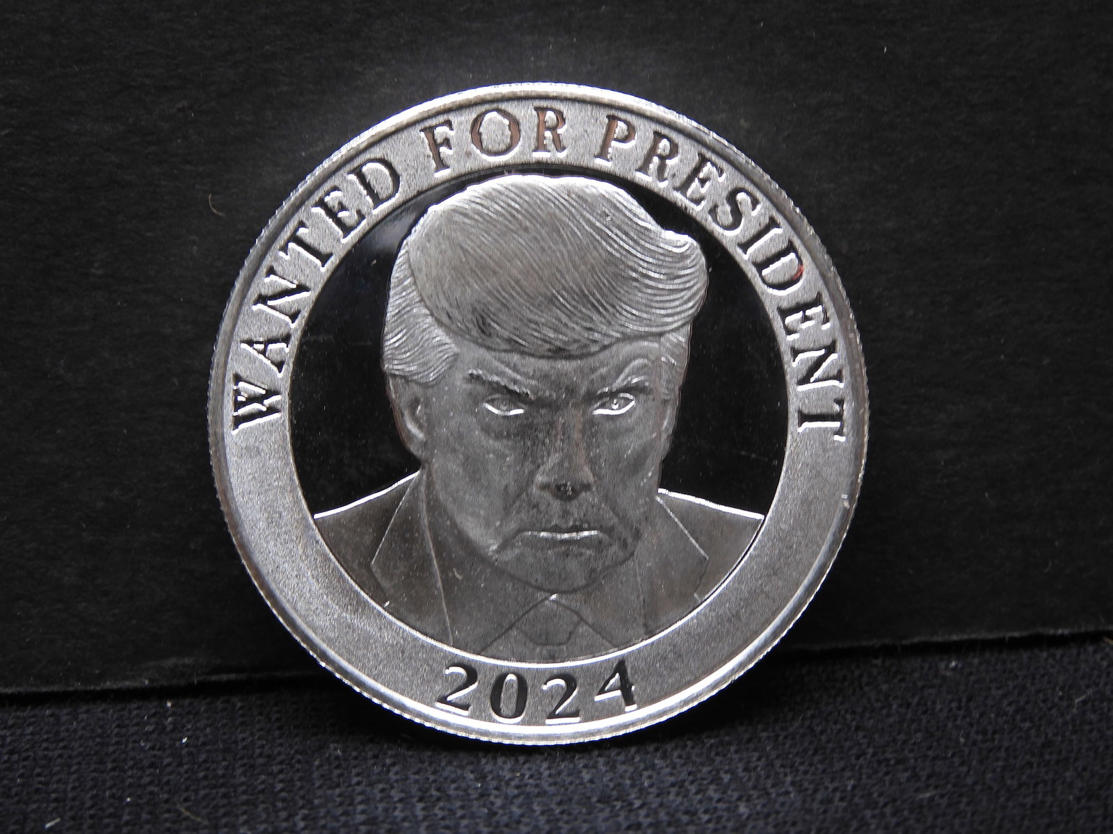 One ounce .999 silver Trump Mug Shot “Wanted for President 2024.” Proof like with heavy frosting.: One ounce .999 silver Trump Mug Shot “Wanted for President 2024.” Proof like with heavy frosting.