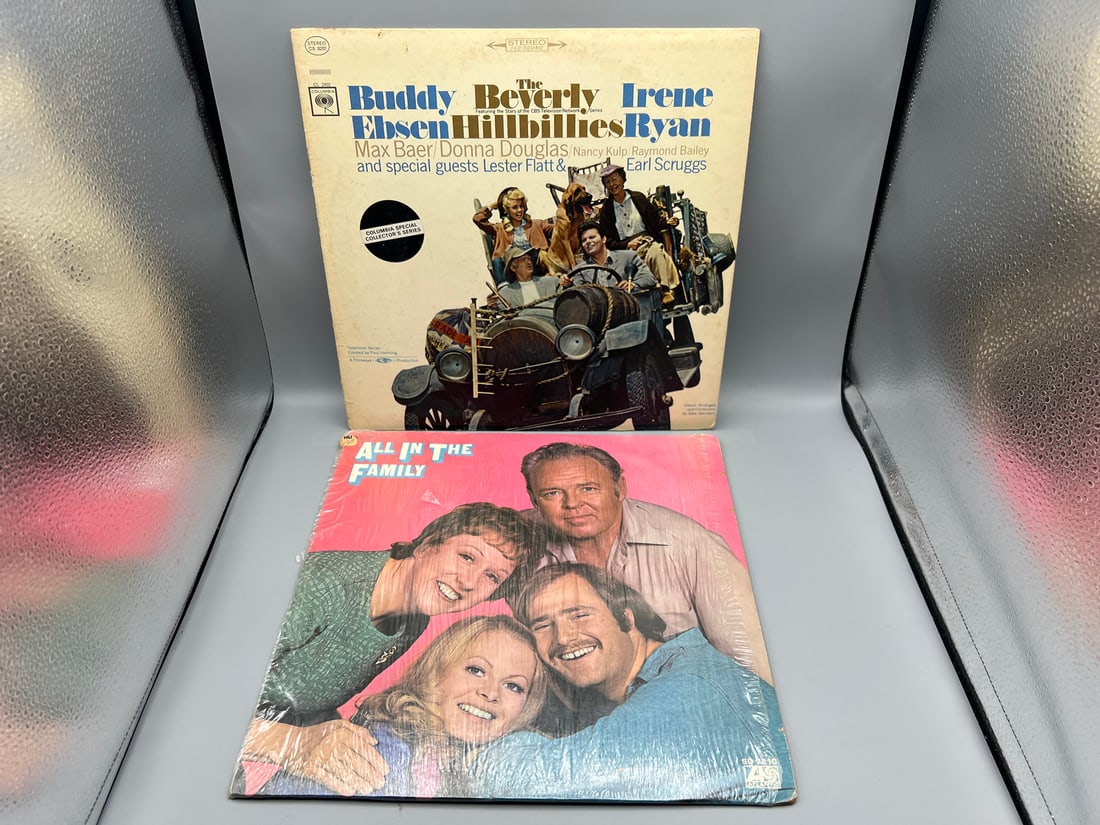 Lot of (2) television show vinyl albums: The Beverly Hillbillies (1966) – cover shows slight: Lot of (2) television show vinyl albums: The Beverly Hillbillies (1966) – cover shows slight staining; and All in the Family (1971) – includes b/w insert