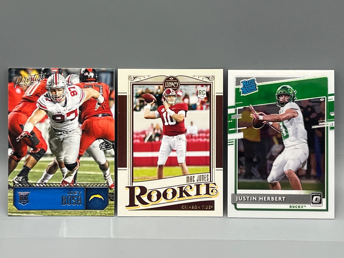 Lot of (3) Modern Football Star Player Rookie Cards - Varying Conditions - Joey Bosa, Mac Jones,: Lot of (3) Modern Football Star Player Rookie Cards - Varying Conditions - Joey Bosa, Mac Jones, Justin Herbert