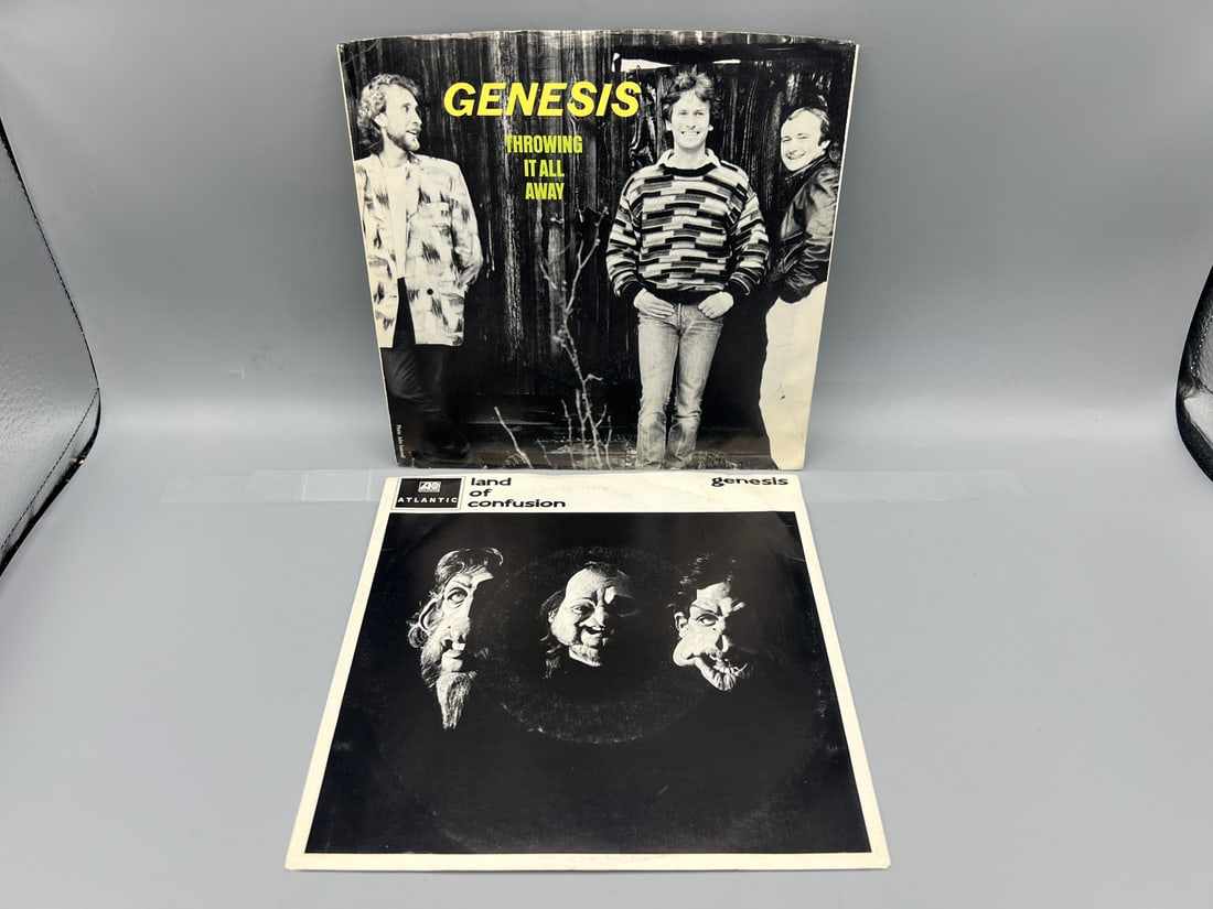 Lot of (2) Genesis 7-inch, 45 rpm records with picture sleeves: Throwing it All Away (1986) and Land (1 of 4)