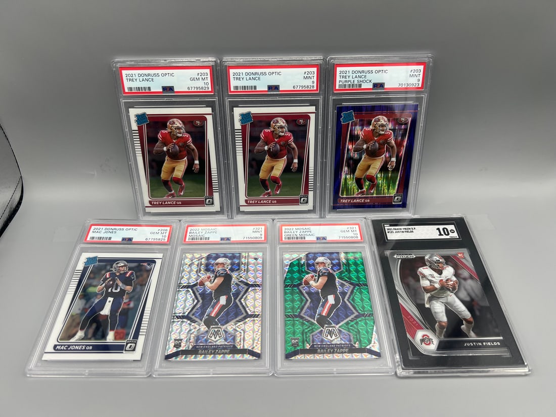 Lot of (7) Assorted Football Quarterback Graded Rookie Cards - Justin Fields, Bailey Zappe, Mac: Lot of (7) Assorted Football Quarterback Graded Rookie Cards - Justin Fields, Bailey Zappe, Mac Jones, Trey Lance