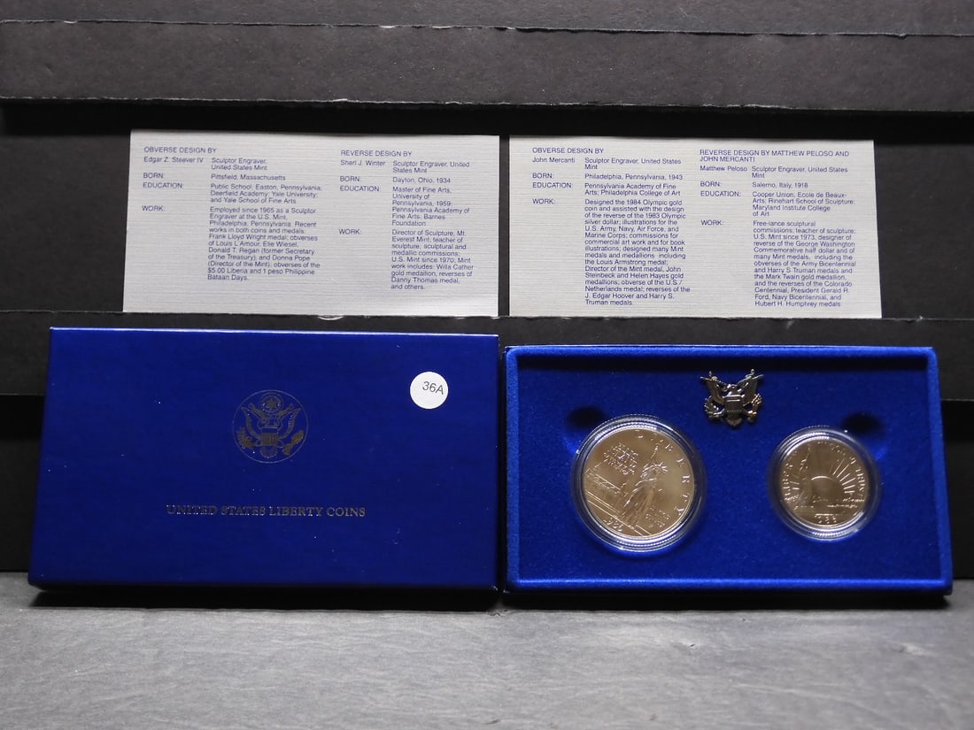 1986 P Ellis Island silver dollar and 1986-D Ellis Island clad half in nice original box plus COAs.: 1986 P Ellis Island silver dollar and 1986-D Ellis Island clad half in nice original box plus COAs. GEM BU.