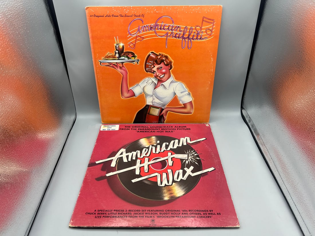 Two (2) Original Movie Soundtrack LPs: American Graffitti (1973), 2 LPs, gatefold; and American Hot: Two (2) Original Movie Soundtrack LPs: American Graffitti (1973), 2 LPs, gatefold; and American Hot Wax (1978),2 LPs, promo label, promo hole/sticker on cover, gatefold