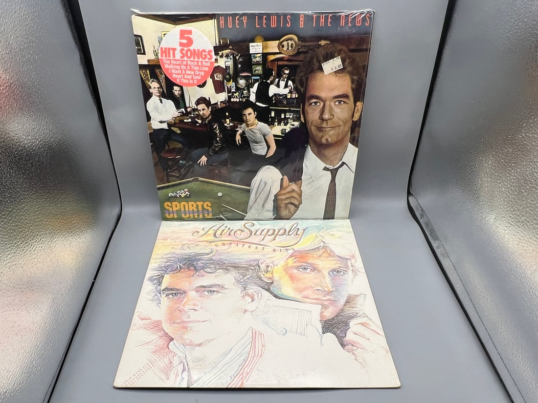 Two (2) LP Lot: Huey Lewis and the News: Sports (1983), in original shrinkwrap with hype sticker;: Two (2) LP Lot: Huey Lewis and the News: Sports (1983), in original shrinkwrap with hype sticker; and Air Supply: Greatest Hits (1983)
