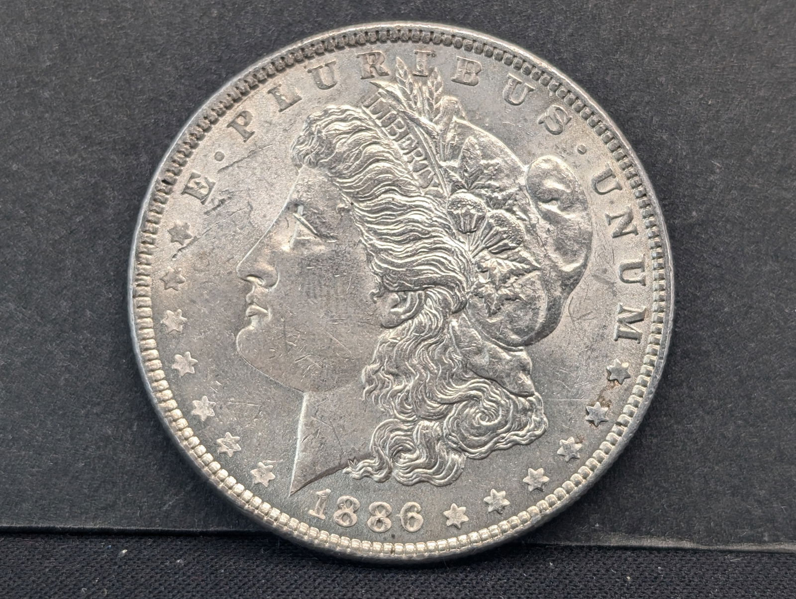 1886 Morgan Silver Dollar  BU (1 of 2)