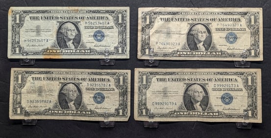 Four 1957 $1 Blue Seal Silver Certificates.