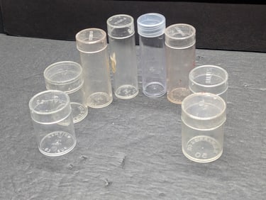 Eight Assorted Empty Coin Tubes