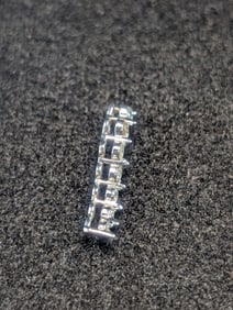 10K White Gold Pendant With 7 Granulated Size Diamonds. 0.8 grams.