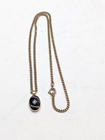 18 inch gold filled cable chain with black onyx and crystal pendant.?